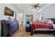 Bright main bedroom features tray ceilings, a ceiling fan, and sliding doors to the outdoor space at 9149 Lane Ct, Port Charlotte, FL 33981