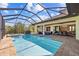 Large screened-in pool and spa with an outdoor grill and dining, and plenty of outdoor seating at 9149 Lane Ct, Port Charlotte, FL 33981