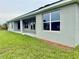 Backyard featuring large windows offering lots of light on a home with neutral siding at 9171 Waldrep St, Port Charlotte, FL 33981