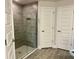 Bathroom featuring glass enclosed shower, neutral tile, with multiple doors and white trim at 9171 Waldrep St, Port Charlotte, FL 33981