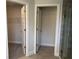 Modern bathroom showcasing a sleek glass shower enclosure, tile floors, and convenient closet access at 9590 Little Rock St, Port Charlotte, FL 33981