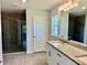 Stylish bathroom featuring granite counters, a large mirror, and a modern glass-enclosed shower at 9590 Little Rock St, Port Charlotte, FL 33981