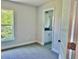 Comfortable bedroom with a large window and plush carpeting, with easy access to an ensuite bathroom at 9590 Little Rock St, Port Charlotte, FL 33981