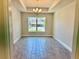 Charming dining room with modern chandelier, tray ceilings, and large windows letting in lots of natural light at 9590 Little Rock St, Port Charlotte, FL 33981