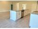 Modern kitchen island with stainless steel appliances, granite countertops, and tile floor at 9590 Little Rock St, Port Charlotte, FL 33981
