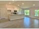 Bright open-concept kitchen featuring granite countertops, modern appliances, and tile flooring at 9590 Little Rock St, Port Charlotte, FL 33981