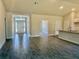 Bright and airy living space with modern flooring, connecting the kitchen and entryway at 9590 Little Rock St, Port Charlotte, FL 33981