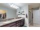 Modern bathroom with granite countertops, double sinks, and a glass-enclosed shower at 10052 Winding River Rd, Punta Gorda, FL 33950