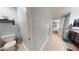 A shot of a bathroom and hallway with light blue walls and white trim at 10052 Winding River Rd, Punta Gorda, FL 33950