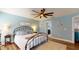 This spacious bedroom features a ceiling fan, wood floors and light blue walls at 10052 Winding River Rd, Punta Gorda, FL 33950