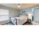 Cozy bedroom with a white ceiling fan, light blue walls, and wood floors at 10052 Winding River Rd, Punta Gorda, FL 33950