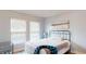 Bedroom with two windows, a bed, and a painting on the wall at 10052 Winding River Rd, Punta Gorda, FL 33950