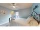 Cozy bedroom with a white ceiling fan, light blue walls, and wood floors at 10052 Winding River Rd, Punta Gorda, FL 33950