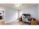 Bedroom with light blue walls, ceiling fan, and a desk with two monitors at 10052 Winding River Rd, Punta Gorda, FL 33950
