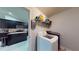 This laundry room features a modern washer and dryer and convenient shelving for storage of supplies at 10052 Winding River Rd, Punta Gorda, FL 33950