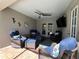 Covered patio featuring wicker furniture with blue cushions, outdoor ceiling fan, and mounted television at 10052 Winding River Rd, Punta Gorda, FL 33950