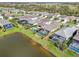 An aerial view showcases the houses with screened in pools in a well-maintained community at 10112 Canaveral Cir, Sarasota, FL 34241