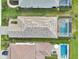Aerial view of the home's roof, screen enclosed patio, and private backyard pool at 10112 Canaveral Cir, Sarasota, FL 34241