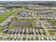 Aerial view of homes surrounding lake in community with a marker on the lake at 10112 Canaveral Cir, Sarasota, FL 34241