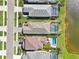 Aerial view of houses featuring screened-in pools and beautiful lake views at 10112 Canaveral Cir, Sarasota, FL 34241