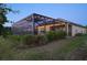 A covered and screened outdoor space with lush greenery, ideal for relaxing and entertaining guests at 10112 Canaveral Cir, Sarasota, FL 34241