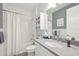 Cozy bathroom with tub/shower, grey countertop, and decorative blue accents at 10112 Canaveral Cir, Sarasota, FL 34241
