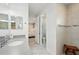 Bathroom with granite countertop, marble tile floor, and glass-enclosed shower at 10112 Canaveral Cir, Sarasota, FL 34241