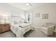 Bedroom with a bed and chair, featuring nautical artwork and sheer curtains at 10112 Canaveral Cir, Sarasota, FL 34241
