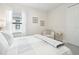 Bedroom featuring a window with blinds, neutral decor and a comfortable armchair at 10112 Canaveral Cir, Sarasota, FL 34241
