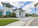 Exterior view of a clubhouse with large columns, a paved walkway, and manicured landscaping, creating a welcoming ambiance at 10112 Canaveral Cir, Sarasota, FL 34241