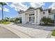 Exterior view of a clubhouse with columns, landscaping, and inviting entrance, creating a welcoming and luxurious feel at 10112 Canaveral Cir, Sarasota, FL 34241