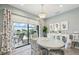 Bright dining area adjacent to the kitchen and lanai featuring coordinated decor and a clear view of the pool at 10112 Canaveral Cir, Sarasota, FL 34241