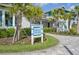 Front exterior view of a building with lush landscaping and a signage out front, inviting ambiance at 10112 Canaveral Cir, Sarasota, FL 34241