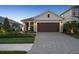 Charming one-story home with a brick driveway and well-manicured landscaping at 10112 Canaveral Cir, Sarasota, FL 34241