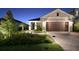 Charming single-Gathering home featuring a well-manicured lawn, stone driveway, and a two-car garage at 10112 Canaveral Cir, Sarasota, FL 34241