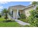 Charming front entrance with a walkway, well-manicured lawn, and lush landscaping at 10112 Canaveral Cir, Sarasota, FL 34241