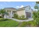 Beautiful single-story home featuring lush landscaping and a brick-paved walkway at 10112 Canaveral Cir, Sarasota, FL 34241