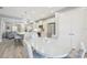 Bright kitchen with stainless steel appliances and gray cabinets that is open to the dining and living areas at 10112 Canaveral Cir, Sarasota, FL 34241