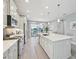 Open kitchen with modern appliances, a large center island, and views of the backyard at 10112 Canaveral Cir, Sarasota, FL 34241