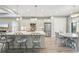 Bright kitchen featuring stainless steel appliances, gray cabinets, and stone countertops open to the dining area at 10112 Canaveral Cir, Sarasota, FL 34241