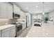 Bright kitchen with stainless steel appliances, gray cabinets, modern countertops, and seamless access to the outdoor living space at 10112 Canaveral Cir, Sarasota, FL 34241