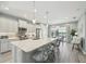 Kitchen with quartz countertops, stainless steel appliances, pendant lighting, and an island with bar stool seating at 10112 Canaveral Cir, Sarasota, FL 34241
