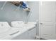 Practical laundry room with washer, dryer, utility sink, and storage shelf at 10112 Canaveral Cir, Sarasota, FL 34241