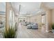 Spacious living area with an open floor plan, large windows, and elegant tile flooring at 10112 Canaveral Cir, Sarasota, FL 34241