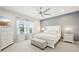 Serene bedroom featuring a large window, neutral tones, and plush bedding at 10112 Canaveral Cir, Sarasota, FL 34241