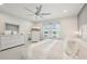 Bright main bedroom with white furniture, large windows, and ceiling fan at 10112 Canaveral Cir, Sarasota, FL 34241