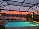 Screened in pool overlooking a beautiful lake and sunset at 10112 Canaveral Cir, Sarasota, FL 34241