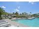 Community pool featuring palm trees, lounge chairs and a splash pad at 10112 Canaveral Cir, Sarasota, FL 34241