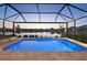 Relaxing pool area with comfortable lounge chairs and an open view of the tranquil lake at 10112 Canaveral Cir, Sarasota, FL 34241