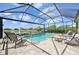 Relaxing pool area with a water view in a screened lanai with lounge furniture at 10112 Canaveral Cir, Sarasota, FL 34241